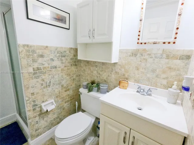 a bathroom with a sink a toilet and mirror