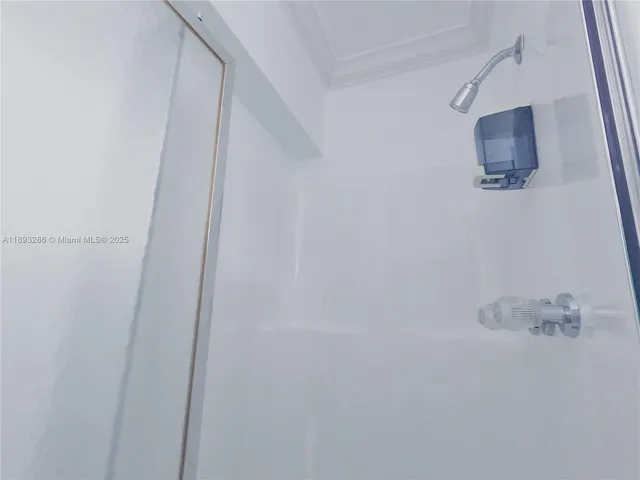 a bathroom with a shower and a sink