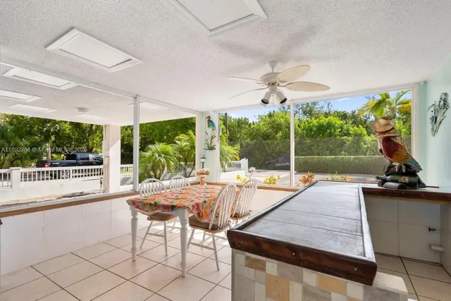 a view of a patio with a table chairs and a backyard