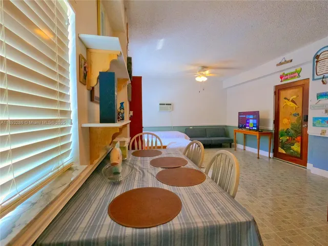 a balcony with table and chairs