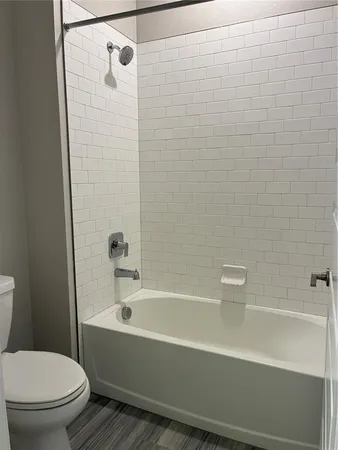 a bathroom with a bathtub and a toilet