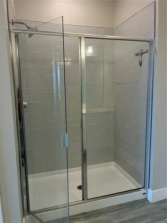 a bathroom with a glass shower door