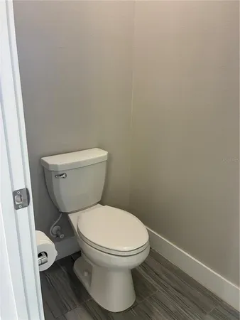 a white toilet sitting next to a small bathroom