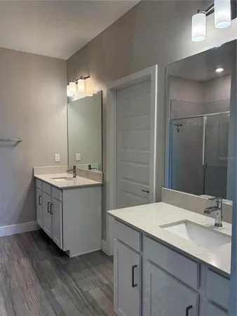a bathroom with a sink double vanity and a mirror