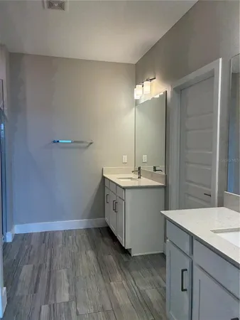 a bathroom with a sink double vanity and a mirror