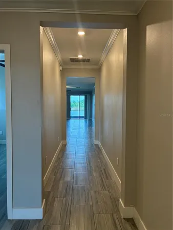 a view of hallway with wooden floor