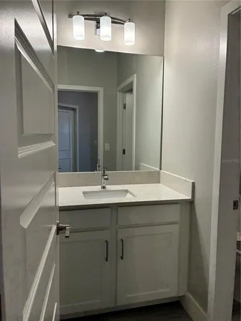a bathroom with a sink and mirror