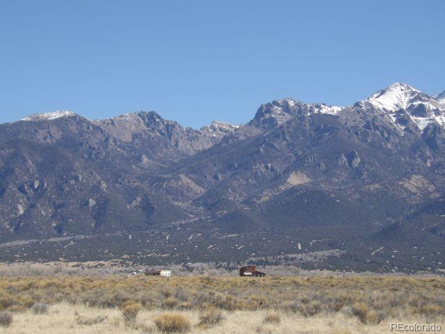 849 Birch Road Crestone, CO 81131 - Photo 5 of 5 a view of a dry yard with mountains in the background