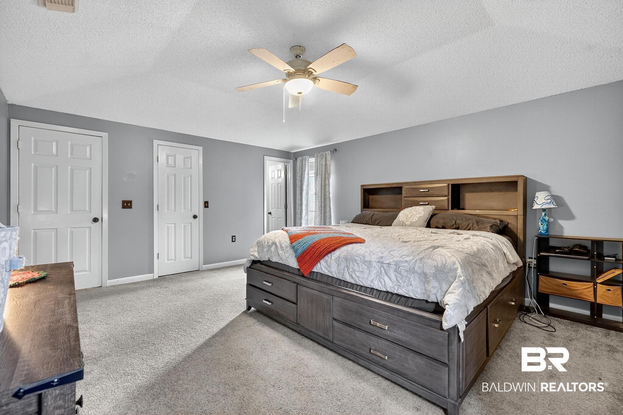 21895 2nd Street Silverhill, AL 36576 - Photo 29 of 43 Primary bedroom featuring light carpet, two closets, and a ceiling fan