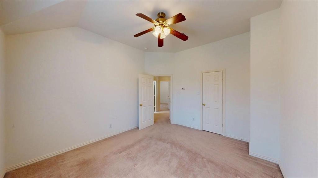 2022 Huntcliffe Court Allen, TX 75013 - Photo 18 of 40 Unfurnished bedroom featuring light carpet, a ceiling fan, and vaulted ceiling