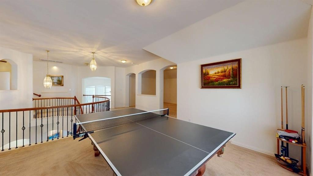 2022 Huntcliffe Court Allen, TX 75013 - Photo 25 of 40 Game room featuring light colored carpet and arched walkways