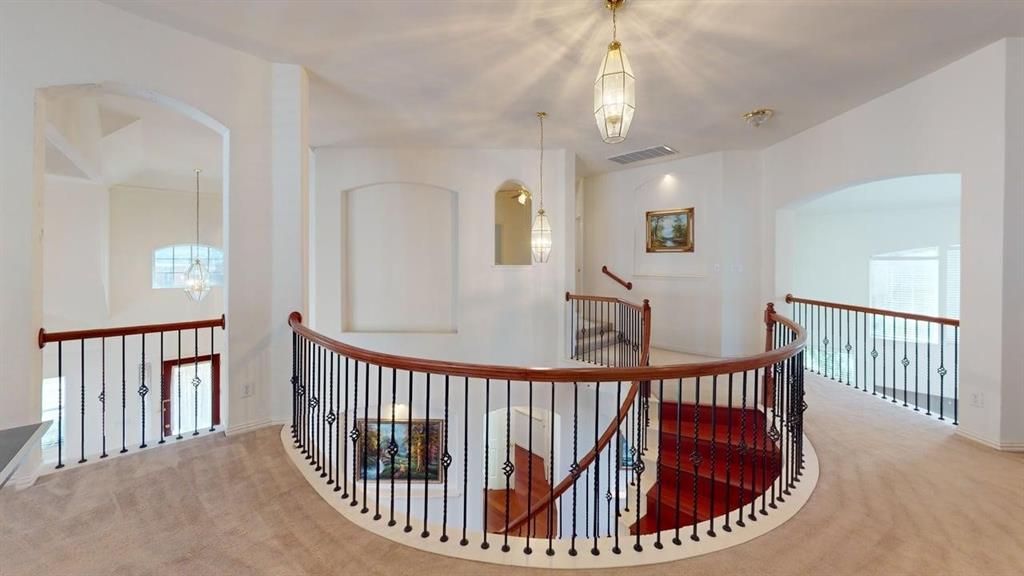 2022 Huntcliffe Court Allen, TX 75013 - Photo 26 of 40 Hallway featuring carpet flooring, an upstairs landing, arched walkways, and healthy amount of natural light