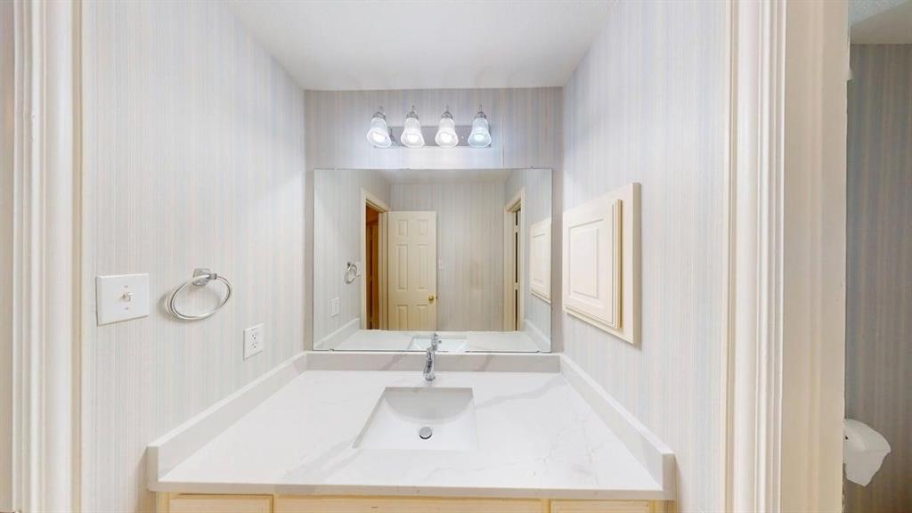2022 Huntcliffe Court Allen, TX 75013 - Photo 32 of 40 Bathroom with vanity and wallpapered walls