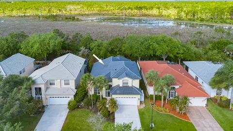 an aerial view of house with yard and lake view