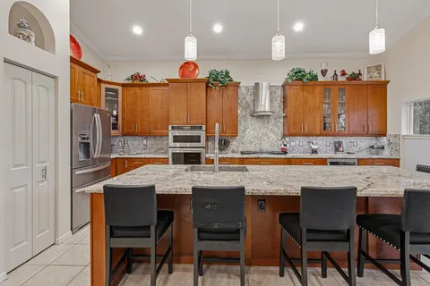 a kitchen with granite countertop a stove microwave and sink