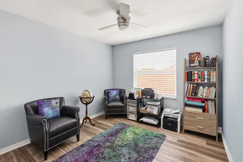a living room with furniture and a floor to ceiling window