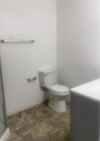 a kitchen with sink a refrigerator and cabinets