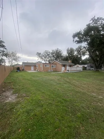 a view of a house with a yard and sitting area