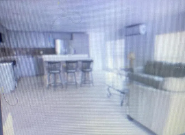 a kitchen with a table chairs sink and cabinets