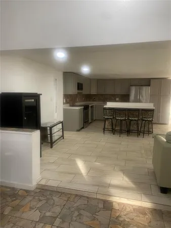 a kitchen with granite countertop white cabinets stainless steel appliances and a sink