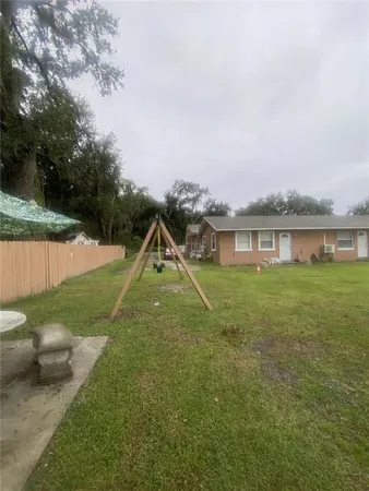 a view of a big yard with a house