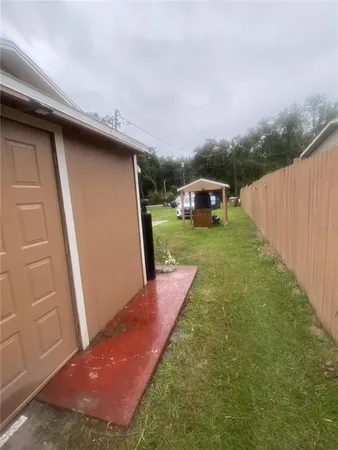 a backyard of a house with table and chairs