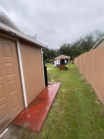 a backyard of a house with table and chairs