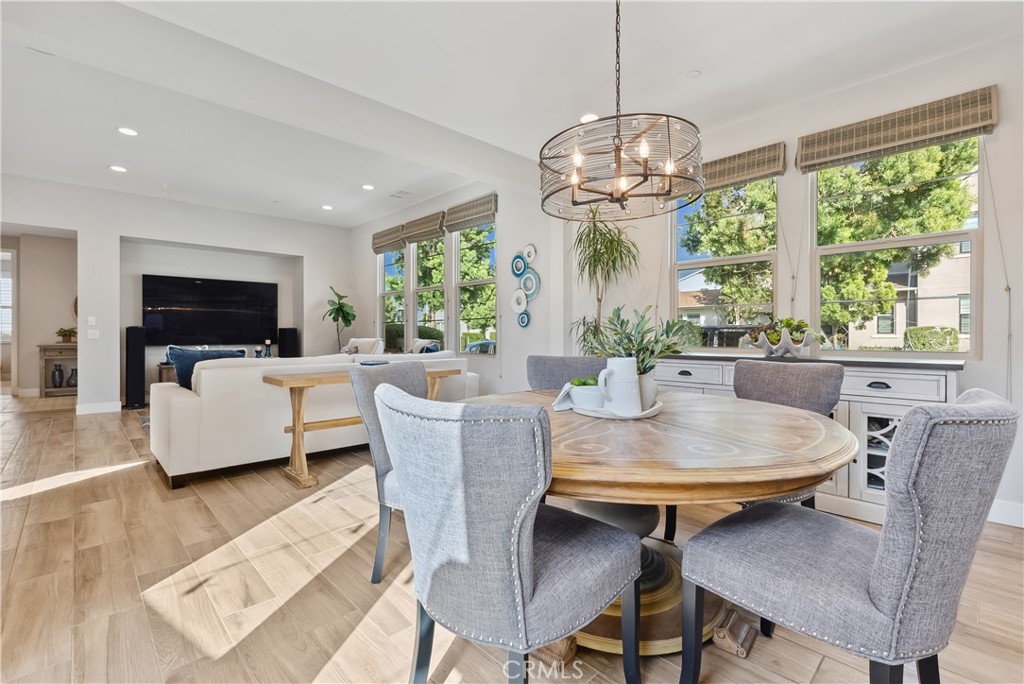 27 Alienta Lane Rancho Mission Viejo, CA 92694 - Photo 12 of 75 a dining room with furniture a chandelier and wooden floor