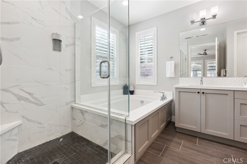 27 Alienta Lane Rancho Mission Viejo, CA 92694 - Photo 17 of 75 a bathroom with a double vanity sink a mirror and a bathtub