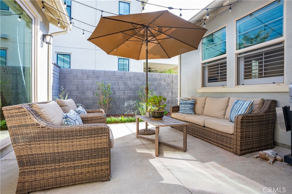 27 Alienta Lane Rancho Mission Viejo, CA 92694 - Photo 23 of 75 a view of a patio with couches chairs under an umbrella