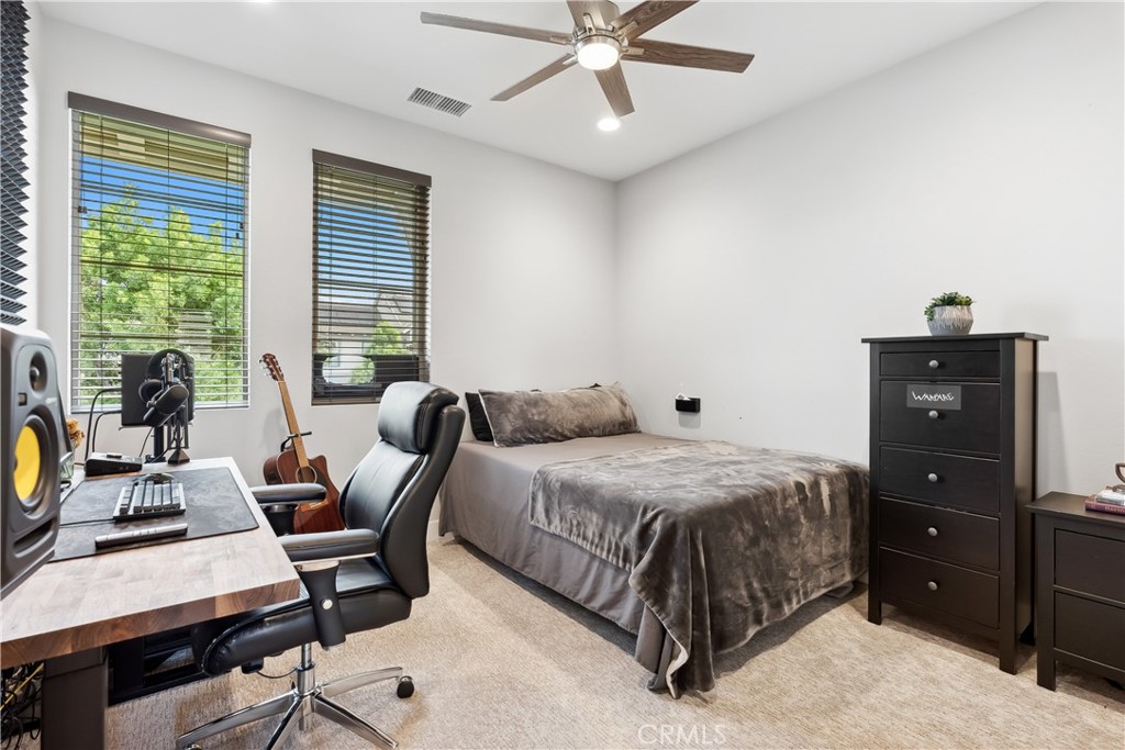 27 Alienta Lane Rancho Mission Viejo, CA 92694 - Photo 27 of 75 a bedroom with a bed and a chandelier