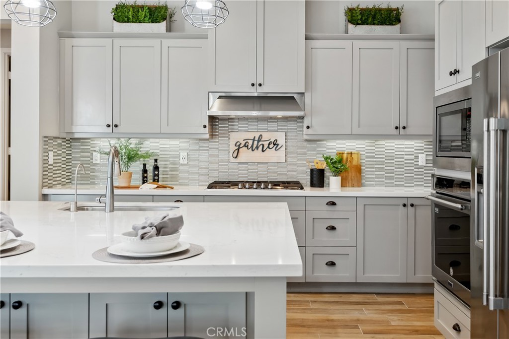 27 Alienta Lane Rancho Mission Viejo, CA 92694 - Photo 3 of 75 a kitchen with stainless steel appliances granite countertop a sink stove and white cabinets