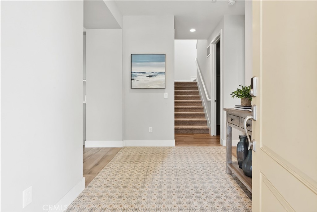 27 Alienta Lane Rancho Mission Viejo, CA 92694 - Photo 32 of 75 a view of a hallway with entryway and wooden floor