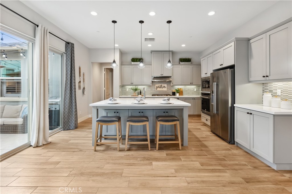 27 Alienta Lane Rancho Mission Viejo, CA 92694 - Photo 5 of 75 a kitchen with stainless steel appliances kitchen island granite countertop a dining table chairs sink and cabinets
