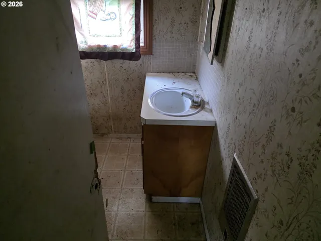 a bathroom with a sink and mirror