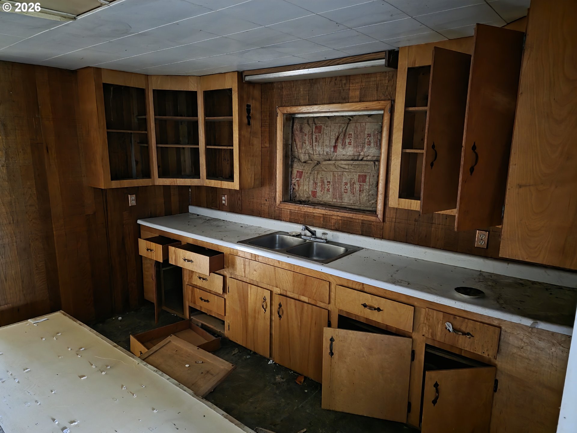 3890 Mill Creek Road Dallas, OR 97338 - Photo 34 of 36 a utility room with stainless steel appliances wooden cabinets a sink and a window