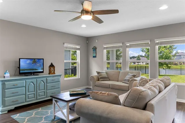 a large kitchen with kitchen island a stove a sink a center island and wooden floor