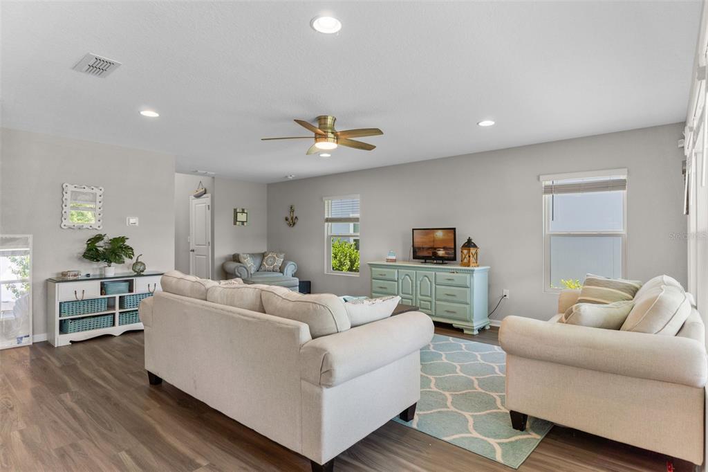562 Meadow Ridge Drive St. Augustine, FL 32092 - Photo 13 of 61 a living room with furniture and a wooden floor