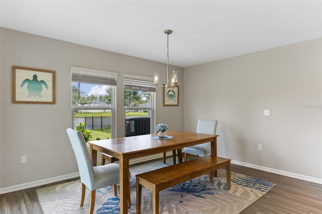 562 Meadow Ridge Drive St. Augustine, FL 32092 - Photo 18 of 61 a view of a dining room with furniture window and wooden floor