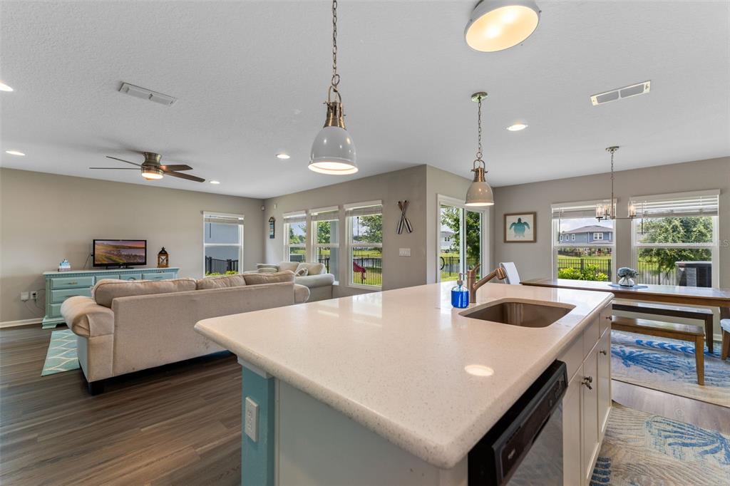 562 Meadow Ridge Drive St. Augustine, FL 32092 - Photo 25 of 61 a large kitchen with kitchen island a sink dining table and chairs