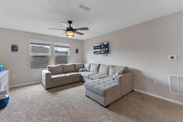 a bedroom with a bed a mirror and next to a window