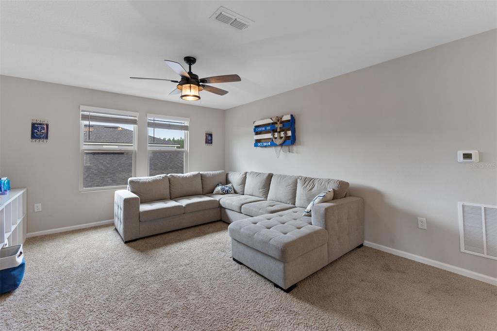 562 Meadow Ridge Drive St. Augustine, FL 32092 - Photo 26 of 61 a living room with furniture and a ceiling fan