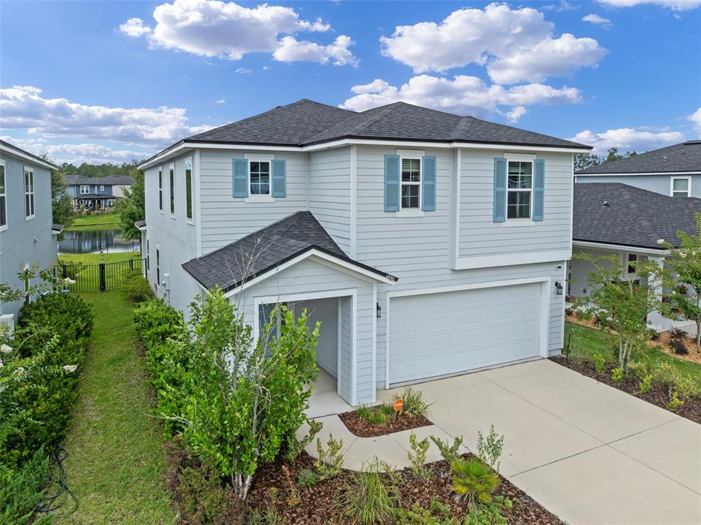562 Meadow Ridge Drive St. Augustine, FL 32092 - Photo 3 of 61 a front view of a house with a garden