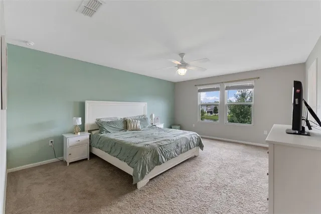 a bathroom with a granite countertop sink a toilet and a mirror