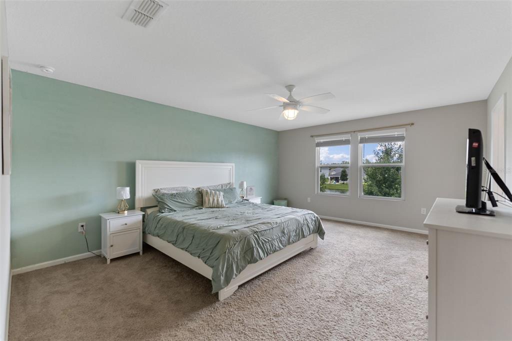 562 Meadow Ridge Drive St. Augustine, FL 32092 - Photo 31 of 61 a bedroom with a bed a mirror and next to a window