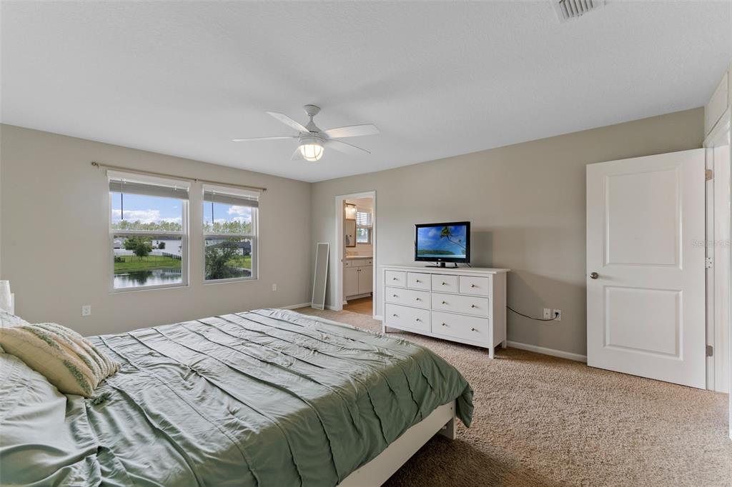 562 Meadow Ridge Drive St. Augustine, FL 32092 - Photo 32 of 61 a bedroom with a bed and a flat screen tv