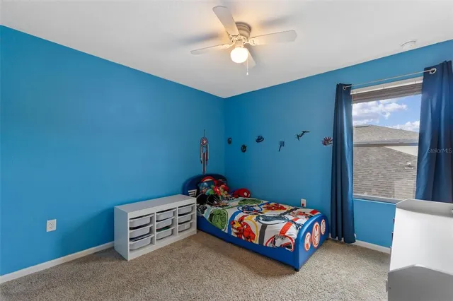 a aerial view of a house with a yard table and chairs