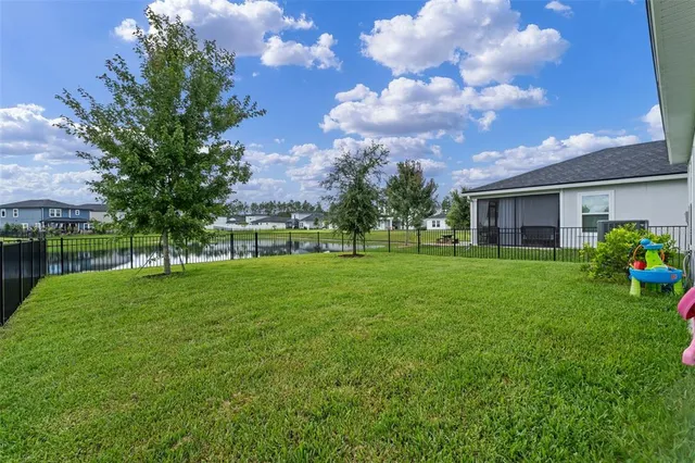 an aerial view of a house with a garden and swimming pool