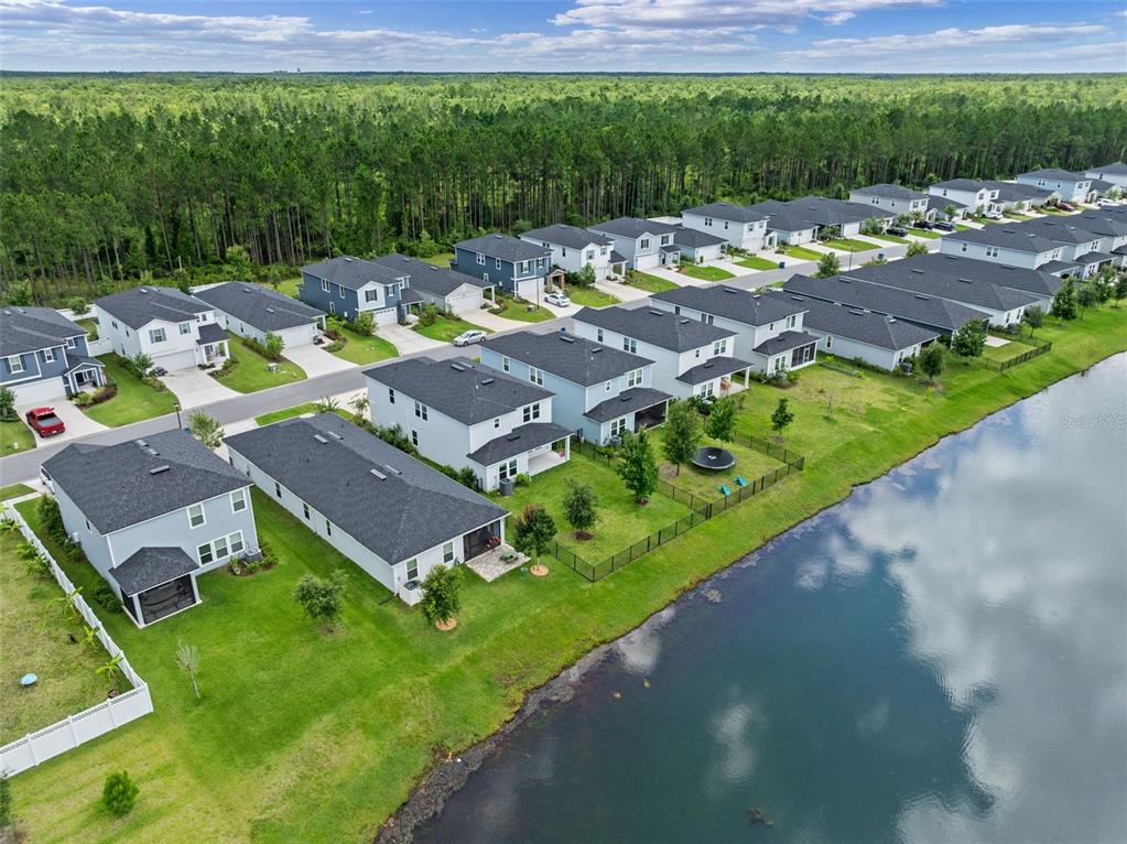 562 Meadow Ridge Drive St. Augustine, FL 32092 - Photo 51 of 61 an aerial view of a house with garden space and street view