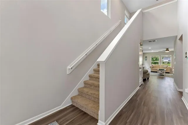 a living room with furniture kitchen view and a large window